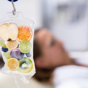 IV drip infusion with fruits symbolizing vitamins, antioxidants, and hydration for brighter, healthier-looking skin