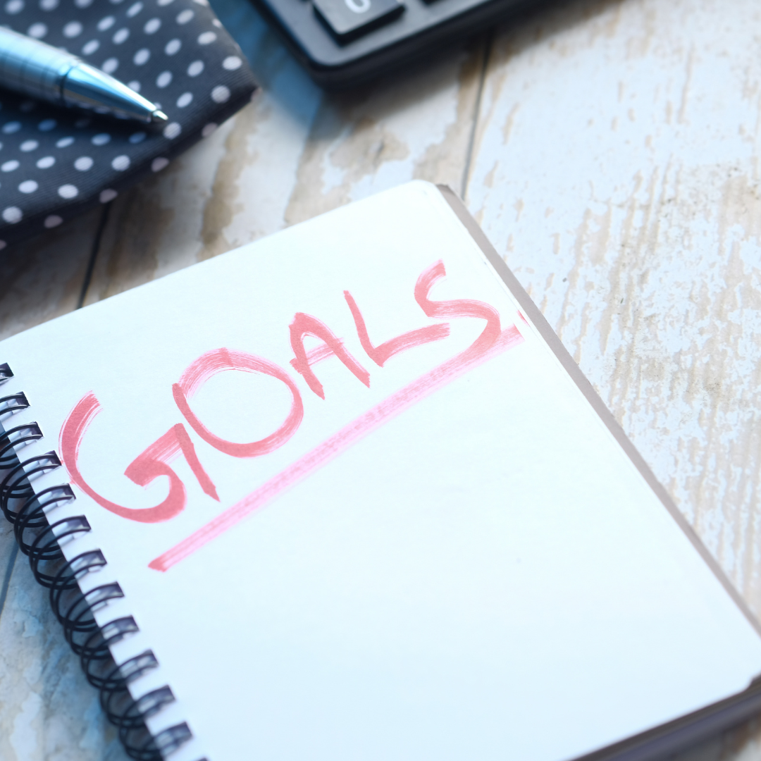 Notebook with the word goals written in red marker, symbolizing wellness planning and intentional health goals for the new year.
